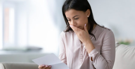 woman reading bad news in letter
