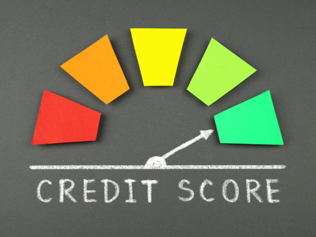 credit score level scale with arrow on blackboard