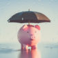 piggy bank with umbrella in rain