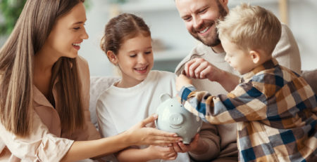 family with piggy bank at home