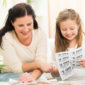 mother and daughter cutting coupons
