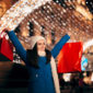 excited shopper holding shopping bags on christmas
